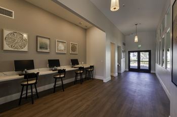 A room with a long table and chairs with a view of a doorway.
